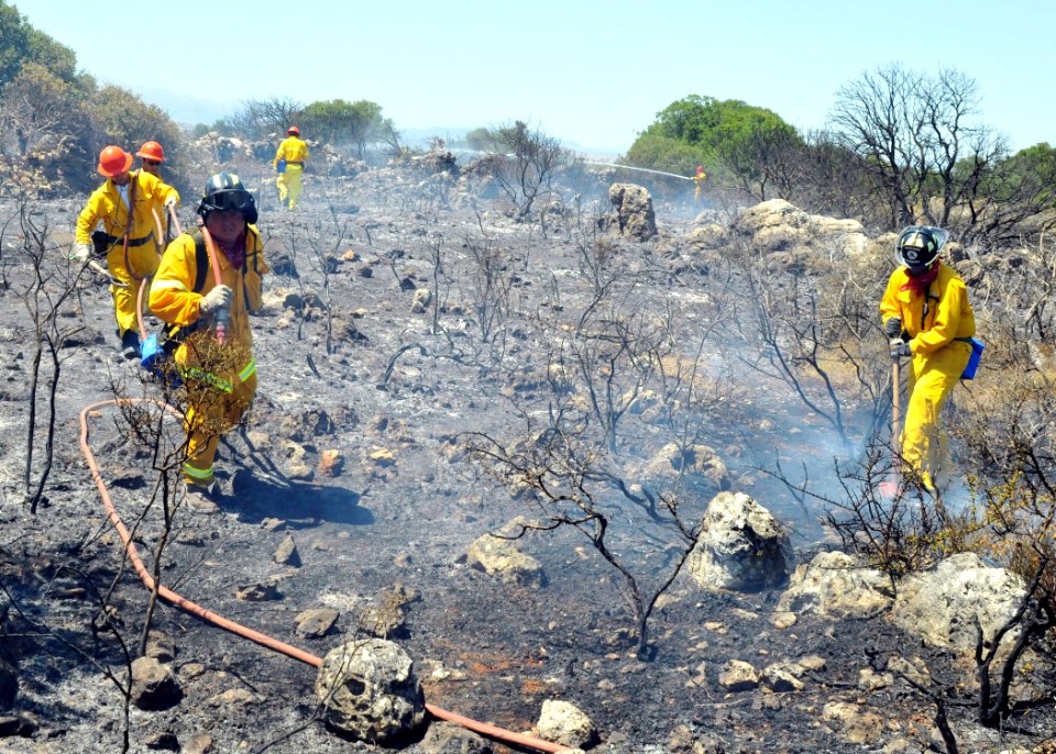 US Navy 090711-N-0780F-002 Naval Support Activity, Souda Bay civilian firefighters mop up the remnants of a brush fire near the village of Pazinos in western Crete