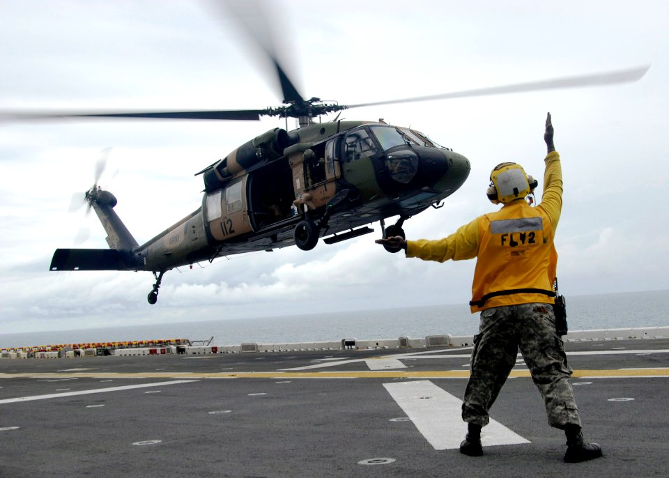 US Navy 090708-N-5215E-078 Aviation Boatswain's Mate (handling) 3rd Class Mario Teasley directs a landing S-70 Black Hawk assigned to the Royal Australian Army during a Deck Landing Qualification