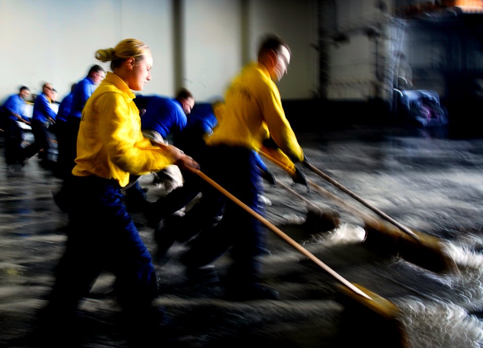 US Navy 090707-N-6538W-033 Aviation Boatswain Mates (Handling) scrub the hangar bay deck aboard the aircraft carrier USS John C. Stennis (CVN 74)
