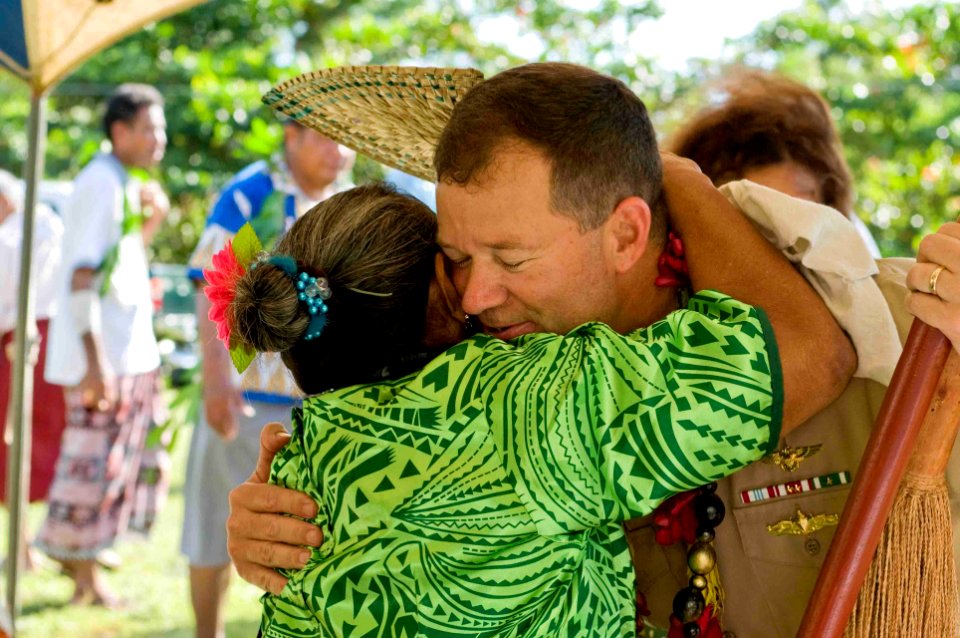 US Navy 090708-N-9689V-006 A woman hugs Capt. John Shaub, deputy mission commander of Pacific Partnership 2009, during a ribbon cutting ceremony celebrating the renovation of the assembly hall