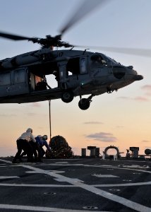 US Navy 090710-N-4236E-314 Sailors aboard the guided-missile destroyer USS Mahan (DDG 72) detach cargo from MH-60S Sea Hawk from Helicopter from Sea Combat Squadron (HSC) 22 during vertical replenishment drills during deck land