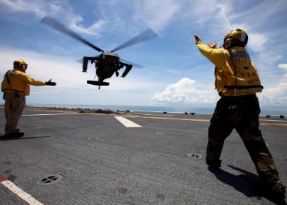 US Navy 100920-M-6740B-062 Sailors aboard the amphibious assault ship USS Iwo Jima (LHD 7) direct a U.S. Army UH-60 Blackhawk helicopter transporti