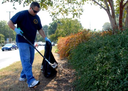 US Navy 100924-N-6764G-043 Aerographer's Mate 1st Class Jonathan Gozalez, assigned to Commander, U.S. 2nd Fleet, collects trash along the U.S. 2nd