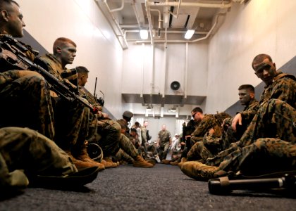 US Navy 100919-N-9950J-290 Marines assigned to the 31st Marine Expeditionary Unit (31st MEU) prepare for a simulated air raid aboard the forward-de photo