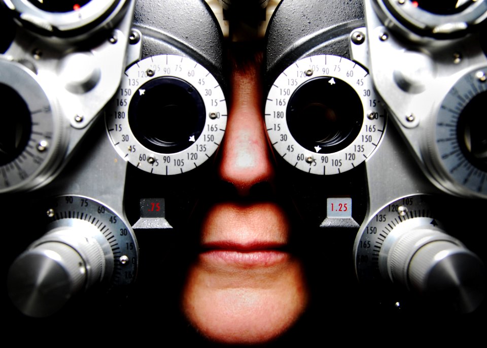 US Navy 100922-N-5821P-032 Cmdr. Amy Burin, assigned to U.S. Naval Forces Central Command, is fitted to a phoropter during an eyeglass prescription