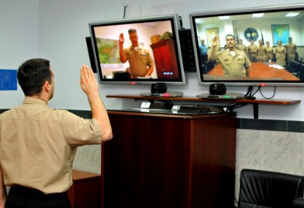 US Navy 100924-N-1512O-006 Mass Communication Specialist 2nd Class William Pittman is administered the oath of enlistment by his father, Rear Adm