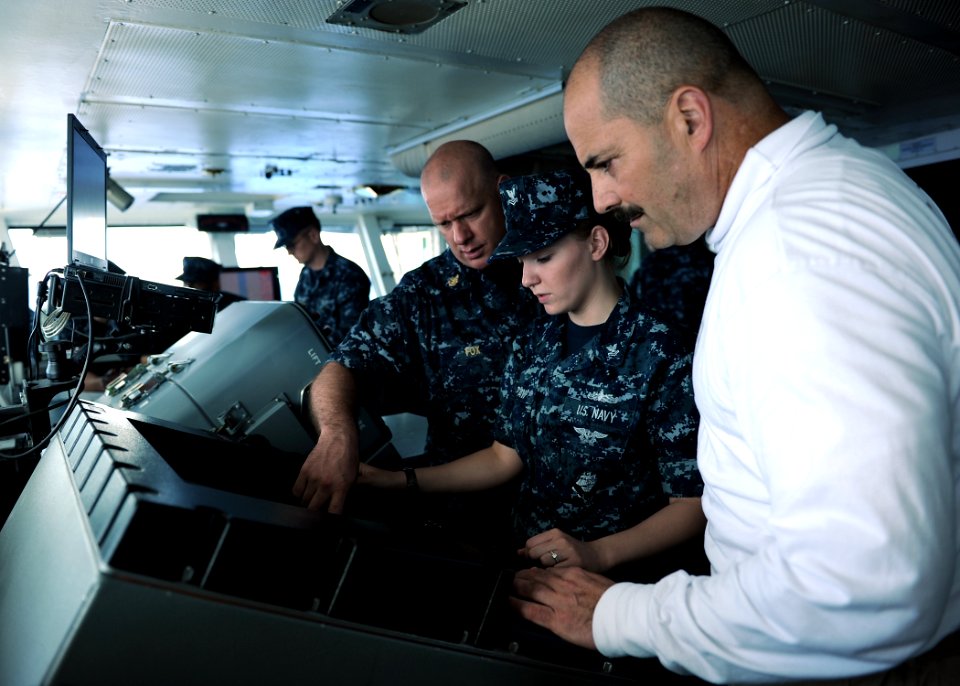 US Navy 100925-N-2821G-065 Senior Chief Quartermaster James Fox and Quartermaster 2nd Class Sarah DeGraw, explain surface contact radar aboard the