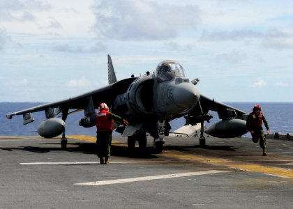 US Navy 100920-N-5538K-224 Marine aviation ordnancemen move away from a AV-8B Harrier jet aircraft after arming a GBU-12 Paveway II laser guided bo