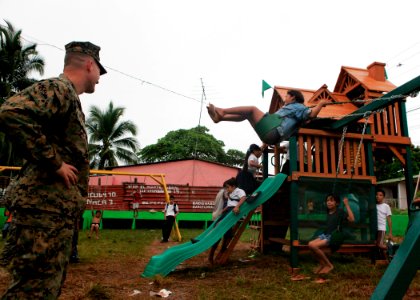 US Navy 100924-M-6740B-391 Lt. Col. Chris S. Richie watches as Nicaraguan children play at the playground that U.S. Marines and Sailors installed