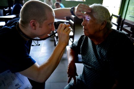 US Navy 100920-N-9964S-081 Lt. Daniel Bowers, embarked aboard the amphibious assault ship USS Iwo Jima (LHD 7), examines a patient during a Continu