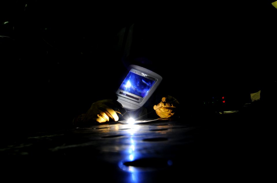 US Navy 100925-N-6427M-101 Hull Maintenance Technician Fireman Ruben Torres, from Bloomington, Ind., practices tungsten inert gas welding aboard t