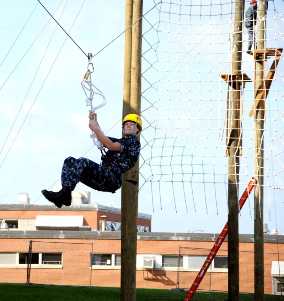 US Navy 100922-N-8848T-846 Officer Candidate Molly Carrigan, from Reno, Nev., zips down a line on the final station of the new 39-foot-tall high ro