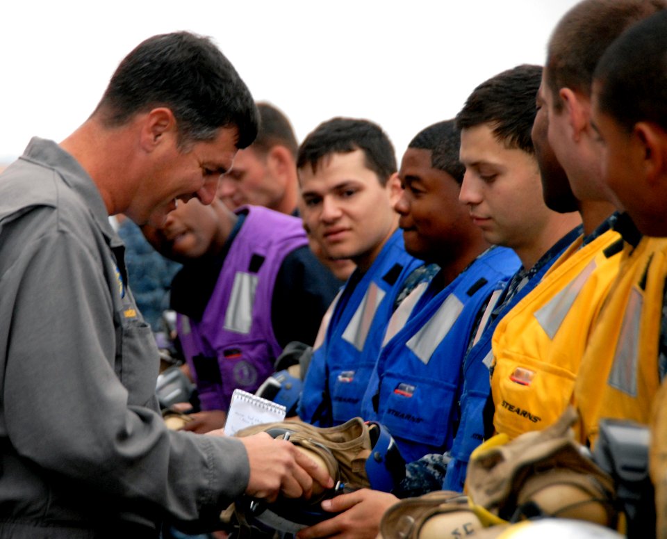 US Navy 100920-N-6552M-111 Capt. Hans Croeber, an inspector with the Board of Inspection and Survey (INSURV), examines cranial helmets aboard the a
