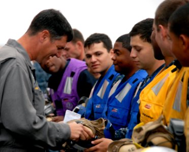 US Navy 100920-N-6552M-111 Capt. Hans Croeber, an inspector with the Board of Inspection and Survey (INSURV), examines cranial helmets aboard the a photo