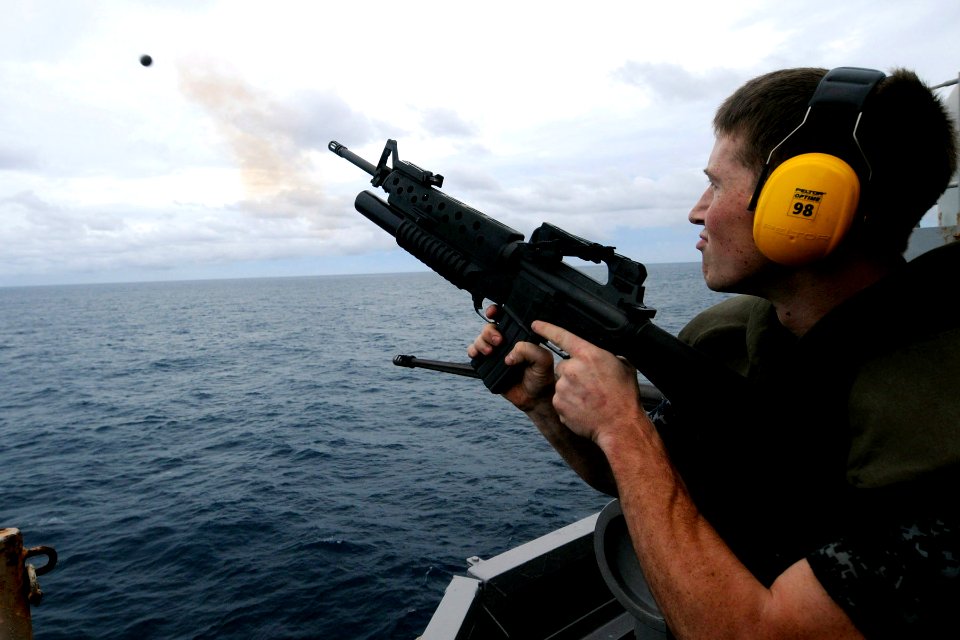 US Navy 100926-N-7680E-410 Gunner's Mate 3rd Class Andrey Murry, from Hickory, N.C., fires a grenade from an M203 grenade launcher during a live-fi