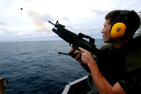 US Navy 100926-N-7680E-410 Gunner's Mate 3rd Class Andrey Murry, from Hickory, N.C., fires a grenade from an M203 grenade launcher during a live-fi