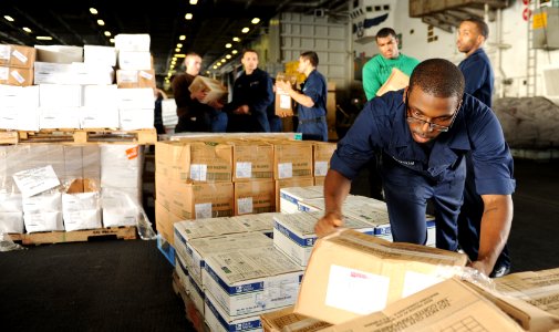 US Navy 100923-N-6362C-071 Machinist's Mate Fireman Gary Benson organizes packages aboard the aircraft carrier USS Harry S. Truman (CVN 75)
