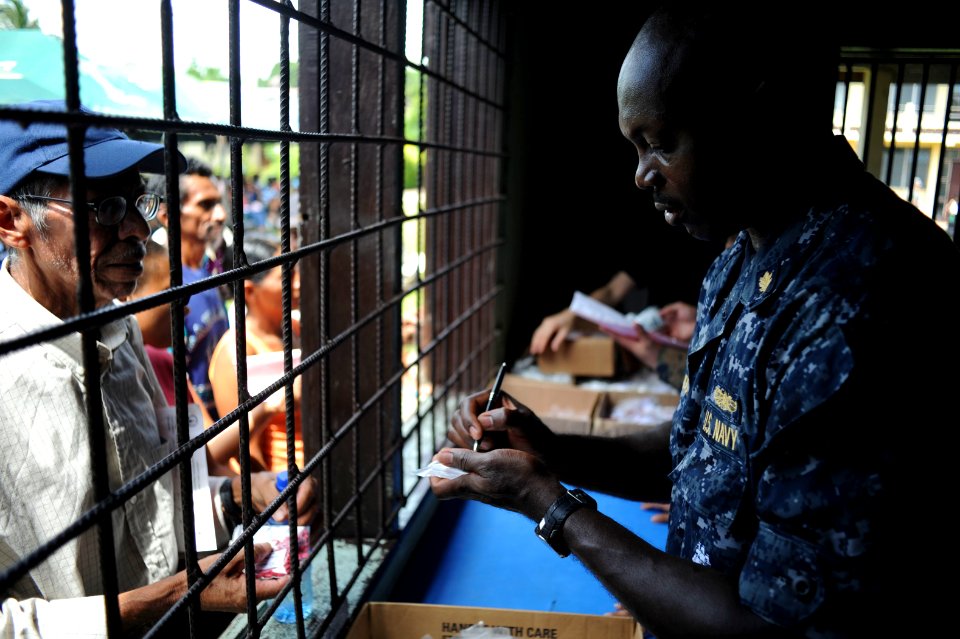 US Navy 100920-N-9964S-129 Lt. Benedict Baidoo writes a prescription for a Nicaraguan man during a Continuing Promise 2010 medical community servic