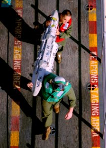 US Navy 100925-N-9950J-080 Sgt. Jeff Bartlett, top, and Cpl. Kevin Carter, both assigned to Marine Attack Squadron (VMA) 542, move an AV-8B Harrier