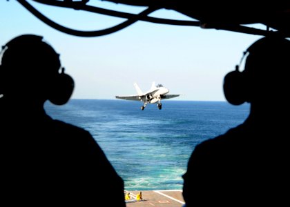 US Navy 100921-N-6632S-048 Sailors observe an F-A-18C Hornet assigned to Strike Fighter Squadron (VFA) 106 approach the aircraft carrier USS George
