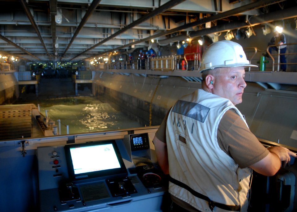 US Navy 100920-N-2218S-012 Chief Boatswain's Mate Michael Thurston backs a landing craft utility out of the well deck of the amphibious assault shi