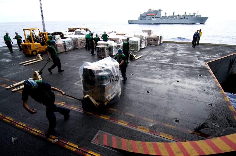 US Navy 100922-N-7191M-075 Supply department Sailors move cargo into the hangar bay aboard the aircraft carrier USS George Washington (CVN 73)