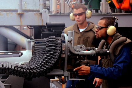 US Navy 100926-N-7680E-143 Air Traffic Controller 2nd Class Leonard Collins, from Marianna, Ark., fires a MK 38 25mm chain gun