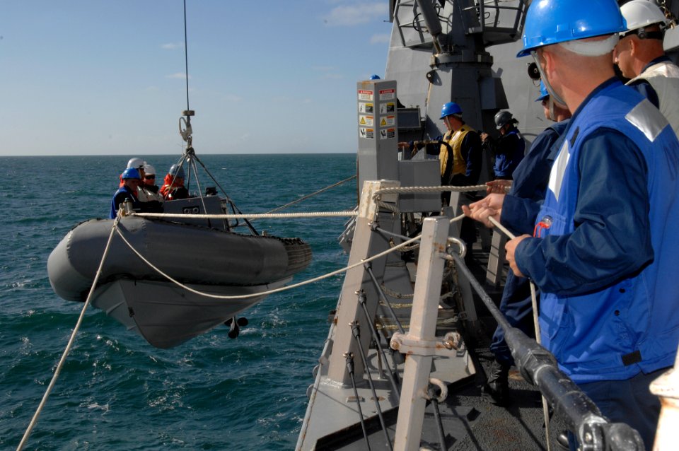 US Navy 100929-N-2855B-048 Sailors lower a rigid-hull inflatable boat into the water during routine training operations