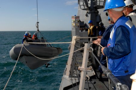US Navy 100929-N-2855B-048 Sailors lower a rigid-hull inflatable boat into the water during routine training operations