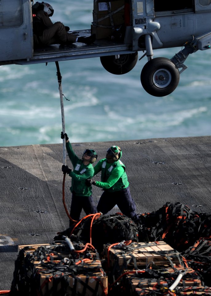 US Navy 100923-N-6427M-134 Sailors aboard the aircraft carrier USS Harry S. Truman (CVN 75) connect a cargo pallet to an MH-60S Sea Hawk helicopter