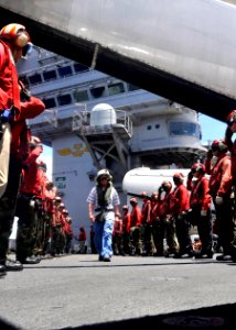 US Navy 100919-N-7103C-007 Cmdr. Dan Carscallen is saluted by Aviation Ordnancemen aboard the aircraft carrier USS George Washington (CVN 73) on hi