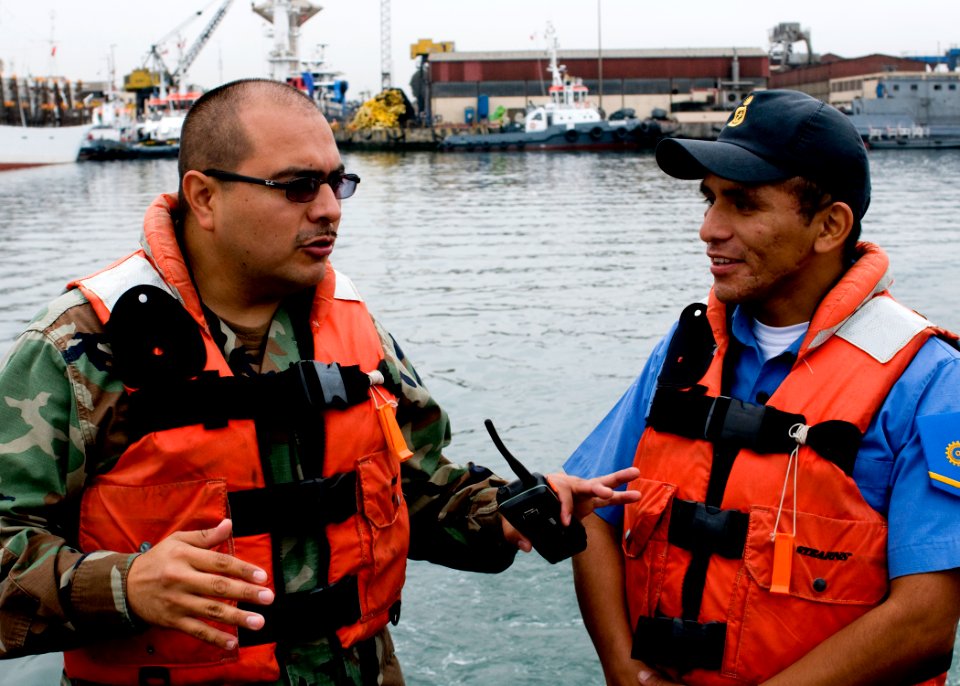 US Navy 100920-N-9095H-008 Chief Boatswain's Mate Jack Bustillos, left, mission commander of the security force assistance mobile training team,