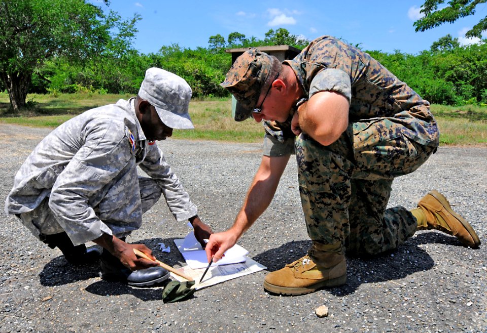 US Navy 100921-N-9643W-218 U.S. Marine Corps Sgt. Edan Valkner, right, embarked aboard High Speed Vessel Swift (HSV 2), helps a member of the Domin