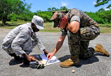 US Navy 100921-N-9643W-218 U.S. Marine Corps Sgt. Edan Valkner, right, embarked aboard High Speed Vessel Swift (HSV 2), helps a member of the Domin photo