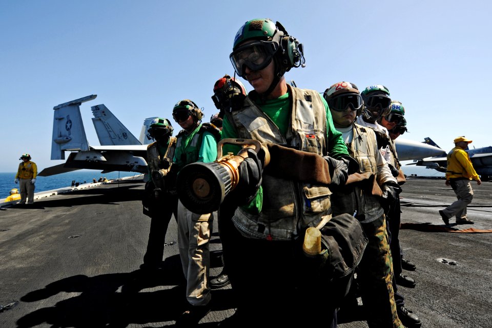 US Navy 100927-N-4135M-032 Sailors and Marines conduct fire fighting and hose handling training aboard the aircraft carrier USS Harry S. Truman (CV