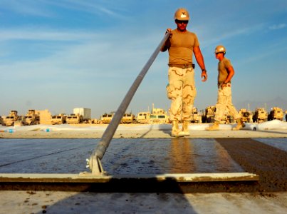 US Navy 100925-N-6436W-106 Seabees assigned to Naval Mobile Construction Battalion (NMCB) 40 place concrete for a project at Camp Deh Dadi II, Afg