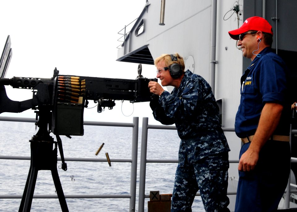 US Navy 100925-N-6632S-286 Rear Adm. Nora Tyson, commander of Carrier Strike Group (CSG) 2, fires a .50-caliber machine gun