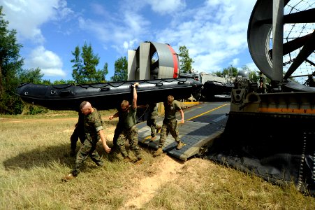 US Navy 100928-N-8335D-873 Marines carry a combat rubber reconnaissance craft off Landing Craft Air Cushion (LCAC) 57 after taking Marines and thei