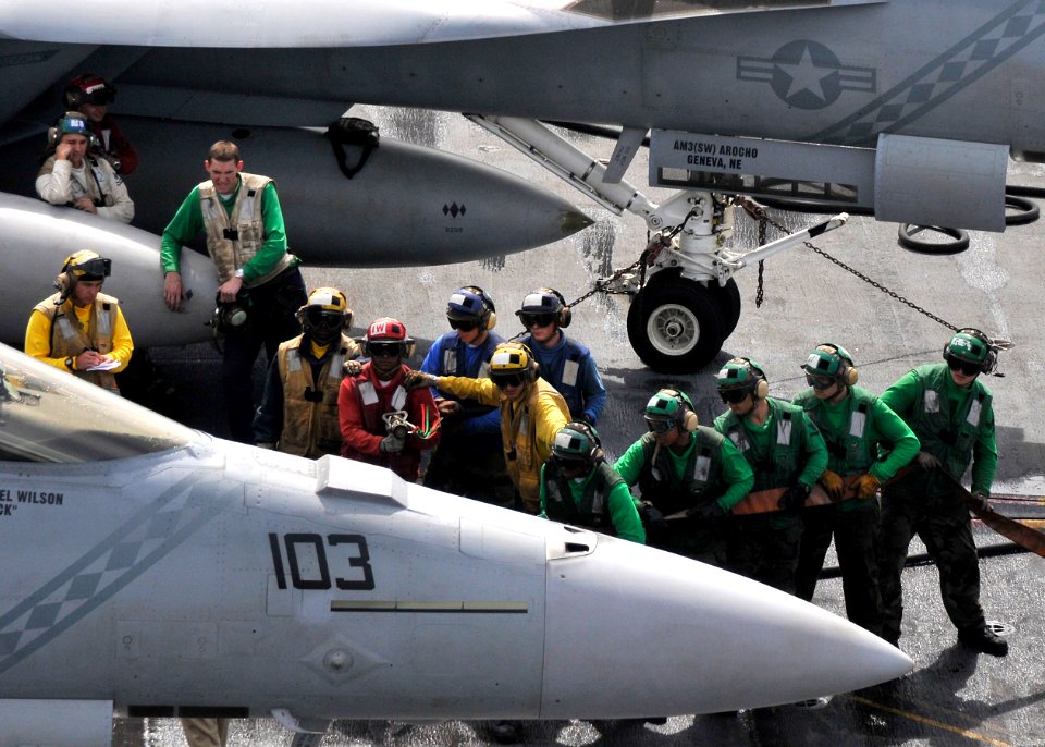US Navy 100930-N-7103C-108 Sailors fight a simulated fire on the nose of an F-A-18F Super Hornet during a mass casualty drill aboard the aircraft c