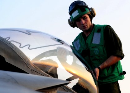 US Navy 100927-N-5538K-112 Lance Cpl. Shaun W. Deibert assigned to Marine Attack Squadron (VMA) 542 cleans the canopy of an AV-8B Harrier jet aircr