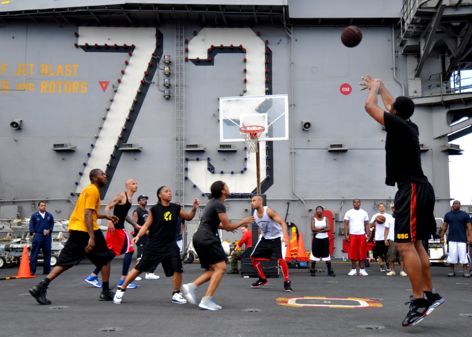 US Navy 100925-N-2013O-225 A Sailor shoots a basket while playing a 3-on-3 basketball game during a steel beach picnic aboard the aircraft carrier