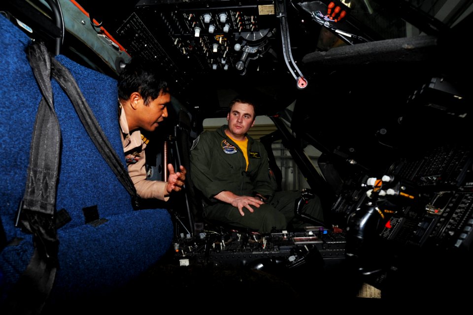 US Navy 101001-N-7191M-078 Lt. Jake Moore, right, assigned to Helicopter Anti-Submarine Squadron (HS) 14, embarked aboard the aircraft carrier USS