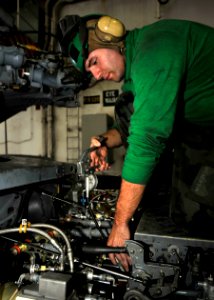 US Navy 100923-N-7103C-094 Aviation Structural Mechanic 2nd Class Eric Wilkinson, from Ellsworth, Maine, greases a mixer assembly on an SH-60B Sea