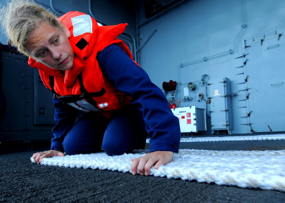 US Navy 100924-N-6632S-095 Boatswain's Mate Seaman Amanda M. Suyre, from the deck department's 3rd division, fakes a line after a larne target evol