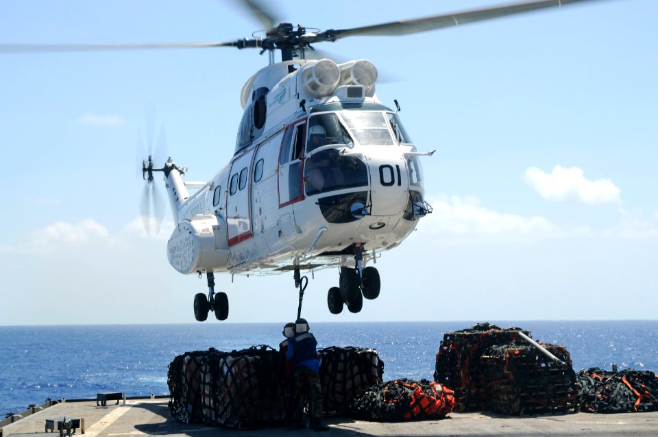 US Navy 100925-N-8335D-545 Damage Controlman Fireman Jasmine Bly and Seaman Arthur Hubbard hook a pole pendant to a Military Sealift Command SA-330