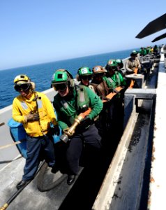 US Navy 100927-N-4135M-069 Sailors and Marines stand by as a backup fire hose team during a fire drill aboard the aircraft carrier USS Harry S. Tru
