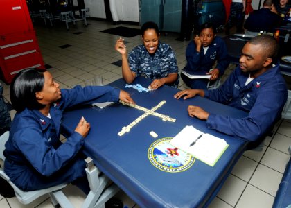 US Navy 100926-N-6632S-130 Sailors assigned to the aircraft carrier USS George H.W. Bush (CVN 77) play a game of dominos in the ship's galley