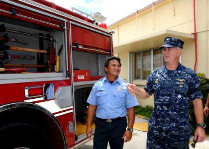 US Navy 101001-N-1906L-025 Capt. Richard Wood discusses the features of a new fire truck with Nicholas Perez following a ribbon cutting ceremony