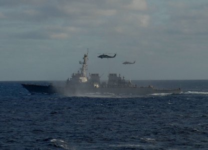 US Navy 100927-N-2855B-203 USS Stout (DDG 55) cruises through the Atlantic Ocean while two SH-60B Sea Hawk helicopters hover close by during routin