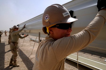 US Navy 100928-N-0475R-311 Equipment Operator Constructionman Cristina Tommeraasen and Seabees run a steel pick through an ultimate building machin